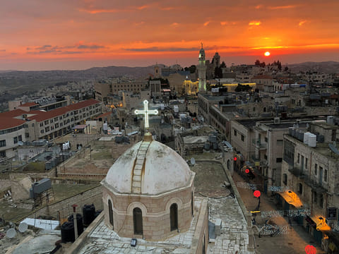 A view shows the dome of the Assyrian church facing a mosque minaret at Manger Square where the Church of the Nativity is located, in Bethlehem 