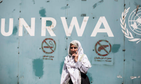 An elderly female protester stands outside the gate of the UN Relief and Works Agency office in Gaza in this file picture.