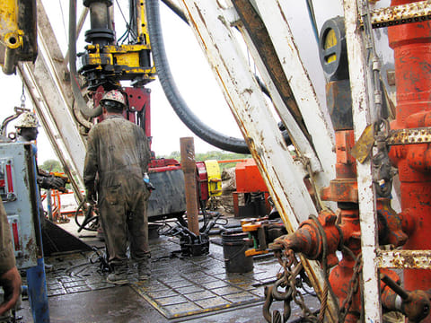 Workers hired by U.S. oil and gas company Apache Corp drill a horizontal well in the Wolfcamp Shale in west Texas Permian Basin near the town of Mertzon, Texas.
