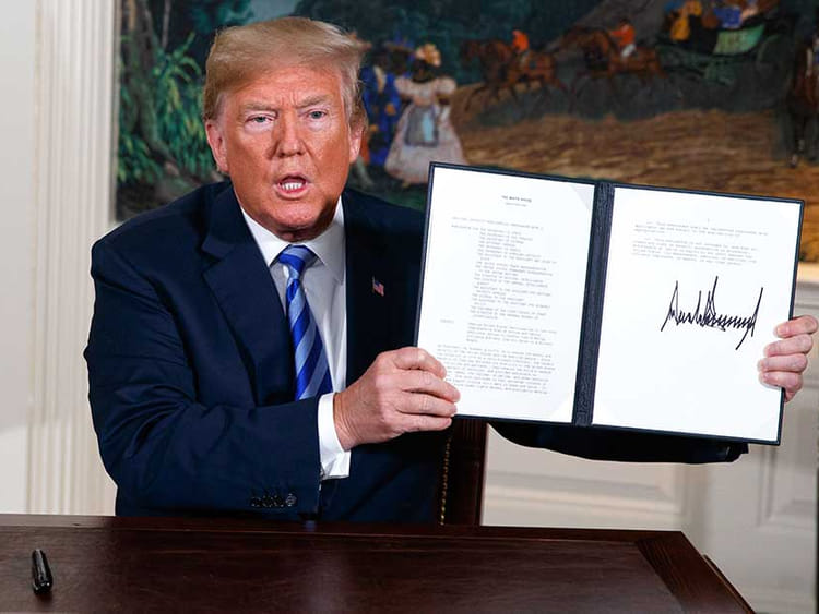 President Donald Trump shows a signed Presidential Memorandum after delivering a statement on the Iran nuclear deal in a file photo.  
