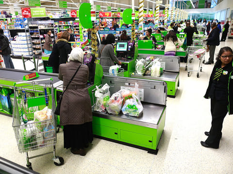 Customers pay for their shopping at self-serve checkout counters inside an Asda supermarket. Trend shows that more shoppers intend to use self-scanning devices to reduce their need to queue.
