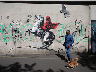 Street artist Banksy splashes Paris with works on refugees