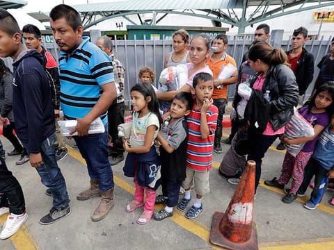 Immigrant families line up to enter the central bus station after they were processed and released by U.S. Customs and Border Protection in McAllen, Texas.