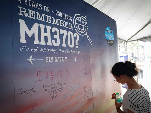A file photo of a girl writing a condolence message during the Day of Remembrance for MH370 event in Kuala Lumpur, Malaysia.