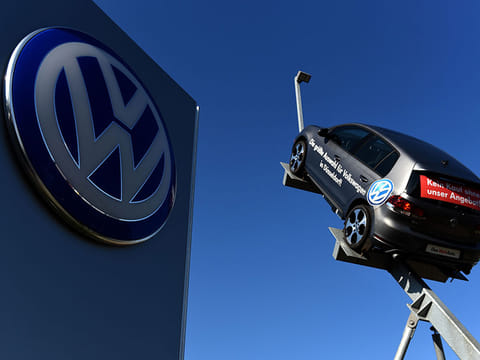 In this file photo taken on September 28, 2015 a model and logo of German car maker Volkswagen (VW) are seen at the entrance to a VW branch in Duesseldorf, western Germany.  