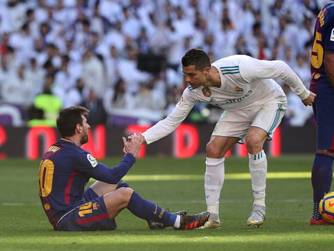 Cristiano Ronaldo helps Lionel Messi get back to his feet