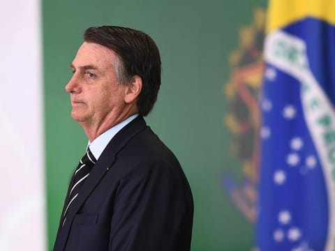 Brazilian President Jair Bolsonaro gestures during a ceremony in which some of the ministers of his cabinet take office a day after the swearing-in of the country's new government, at Planalto Palace in Brasilia, on January 2, 2019
