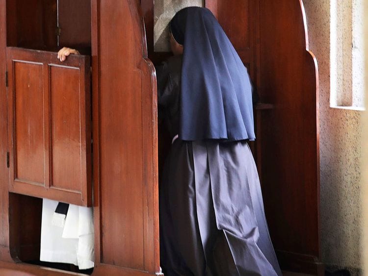 A nun partakes in the sacrament of confession