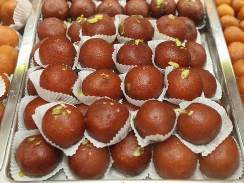 Gulab jamun, which are fried dumplings served in sugar syrup.