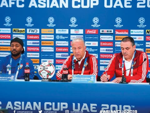 Zaccheroni (centre) interacts with the media ahead of their opening match as Esmail Mattar (left) looks on. 