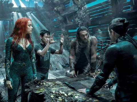 James Wan, second from left, directs a scene in "Aquaman" with, from left, Amber Heard, Jason Momoa and Willem Dafoe.  