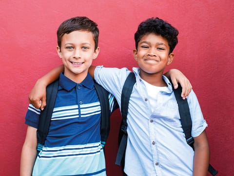 Portrait of multiethnic schoolboys enjoying friendship.