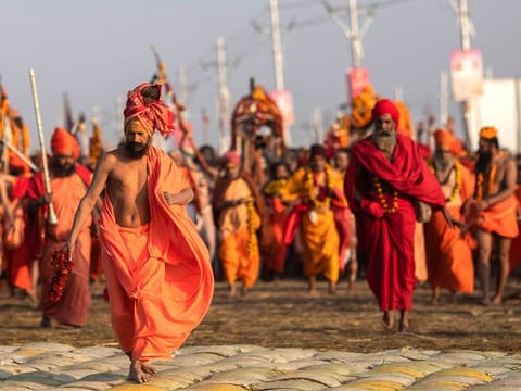 Hindu holy men arrive for ritualistic dip on auspicious Makar Sankranti day during the Kumbh Mela, or pitcher festival in Prayagraj, Uttar Pradesh, on Tuesday, January 15, 2019. 