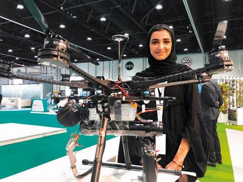 Shouq Mohammad with her ‘Anti-Fire Drone’ at the Abu Dhabi Sustainability Week exhibition.
