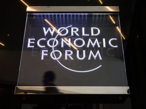 A man walks past a sign of the World Economic Forum (WEF) in Davos, eastern Switzerland  