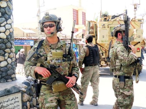 U.S troops keep watch during an official visit in Farah province, Afghanistan