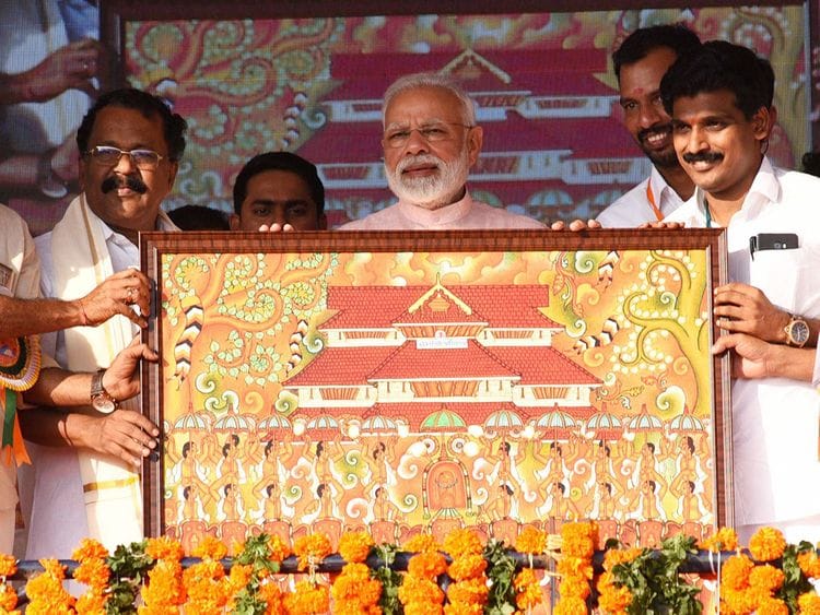 India's Prime Minister Narendra Modi being presented a memento