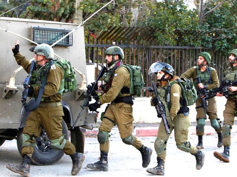 Israeli soldiers clash with Palestinian demonstrators in the West Bank village of Tuqua