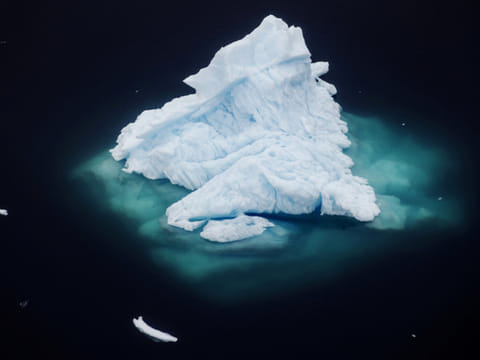 An iceberg floats in a fjord near the town of Tasiilaq, Greenland