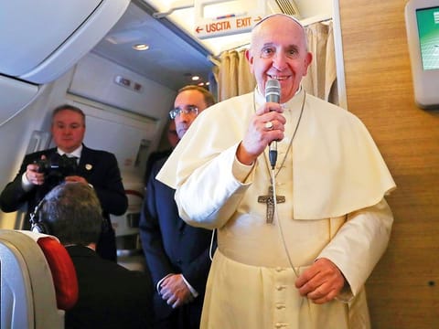 Pope Francis speaks to reporters aboard the plane heading to Abu Dhabi.