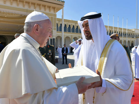 This handout photo released by the Vatican Media, shows Pope Francis (L) gifting Abu Dhabi's Crown Prince Mohamed Bin Zayed Al-Nahyan a copy of the Human Fraternity document ahead of boarding his plane on February 5, 2019.  - RESTRICTED TO EDITORIAL USE - MANDATORY CREDIT "AFP PHOTO / VATICAN MEDIA"