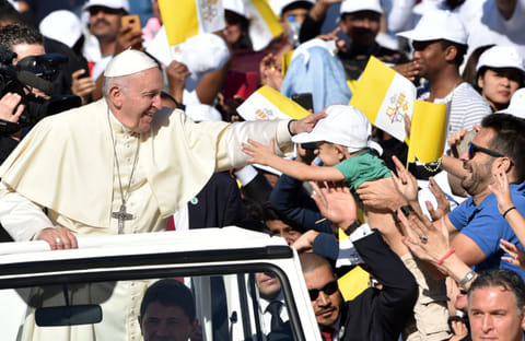 Pope blessing Five-year-old Cyprien Flour at the Zayed sports city stadium in Abu Dhabi.