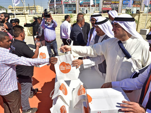 Dawood Al Hajiri and other senior Dubai Municipality officials distribute food packets provided by LuLu Group to dozens of workers in Muhaisnah 2 after launching the food bank on Tuesday.