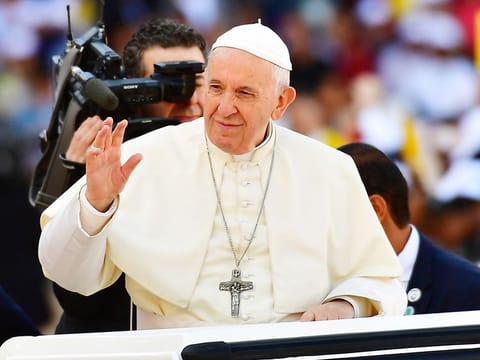 Pope Francis greets the crowd as he arrives to lead mass at the Zayed Sports City Stadium to celebrate a mass in Abu Dhabi.