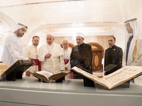 Pope Francis, Dr Ahmad Al Tayyeb and Shaikh Mohammad Bin Zayed look at versions of the Quran, Bible and Torah on loan from the Louvre Abu Dhabi. Seen with Mohammad Khalifa Al Mubarak, Chairman of the Department of Culture and Tourism and Abu Dhabi Executive Council Member.
