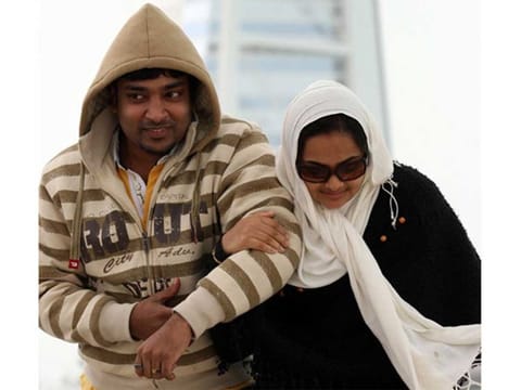 A young couple braves the cold weather in Dubai's Jumeirah beach. 
