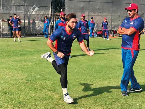 President of Karachi Kings Wasim Akram watches fast bowler Usman Khan bowl during a training session at the ICC Academy.