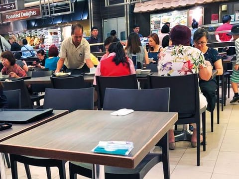 Singaporeans commonly use personal articles such as tissue packets to reserve tables in the city's crowded food courts before purchasing a meal. The practice is considered quintessential "kiasu," which means a fear of losing out.