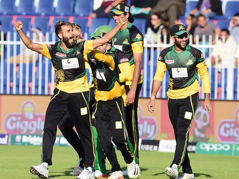Imran Tahir celebrates with Multan Sultans teammates after completing his hat-trick during the PSL clash against Quetta Gladiators at Sharjah International Cricket Stadium during PSL 2018. 