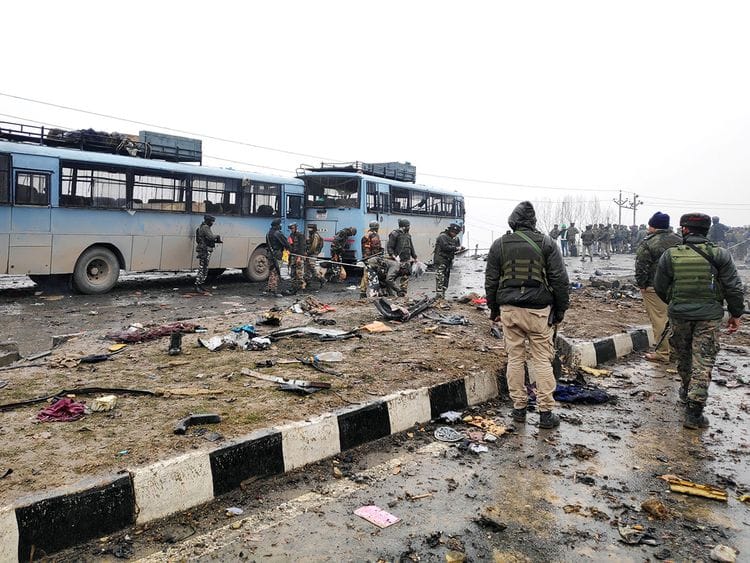 Indian soldiers examine the debris