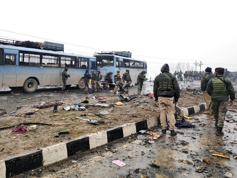 Indian soldiers examine the debris after an explosion in Lethpora in south Kashmir's Pulwama district on Thursday, February 14, 2019. 