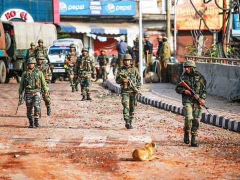 Army personnel patrol a street during a curfew, imposed after clashes between two communities over the protest against the Pulwama terror attack, in Jammu
