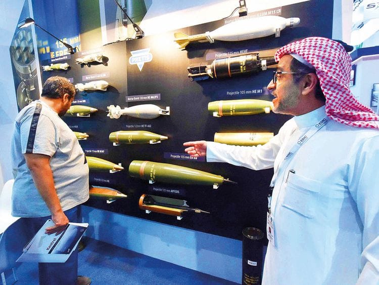A visitor checks out a display of mortar bombs at the pavilion of Bosnia