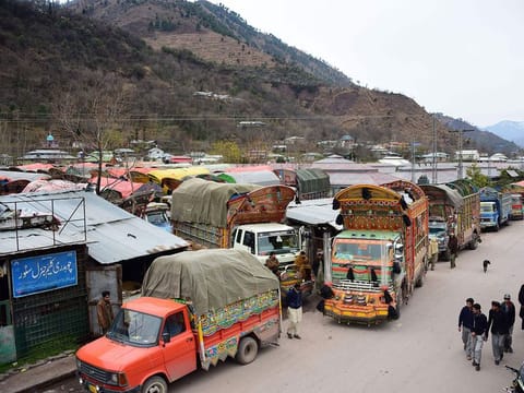 In this picture taken on February 20, 2019, goods trucks are pictured at the border town of Chakothi in Pakistan-administered Kashmir, some 3 km from Line of Control (LoC). 