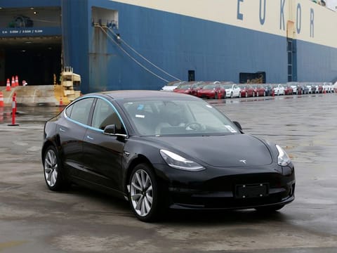 A Tesla Model 3 car leaves a cargo vessel at a port in Shanghai, China.
