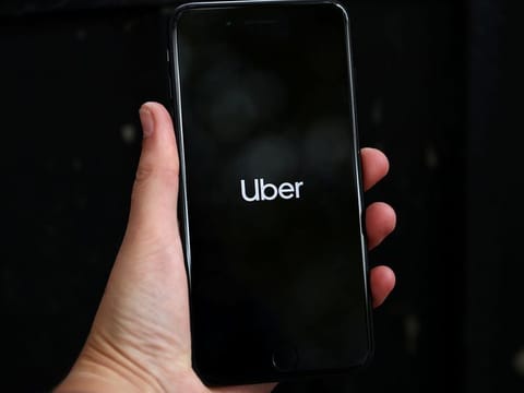 Uber's logo is displayed on a mobile phone [Illustrative file image]
