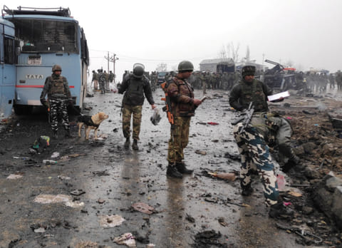 Indian soldiers examine the debris after an explosion in Lethpora in south Kashmir's Pulwama district February 14, 2019. 