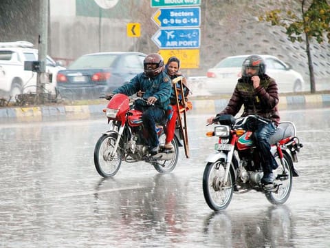 A motorcyclists on their ways at Faisal Avenue amid heavy rain in the federal capital which received an unexpected downpour spell on Monday afternoon. 