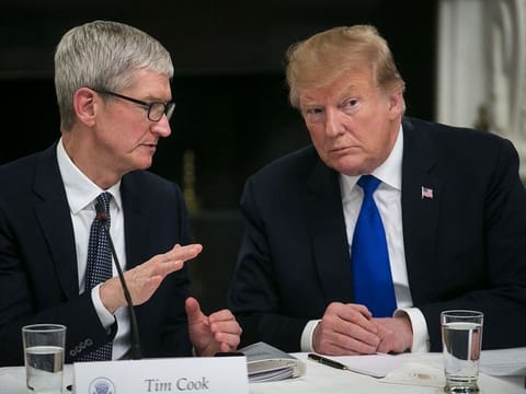 File image: Tim Cook, chief executive officer of Apple Inc., left, speaks with U.S. President Donald Trump 