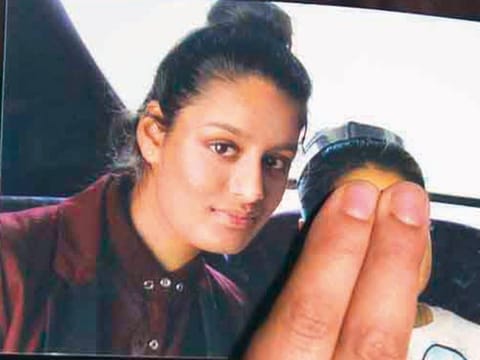 Renu Begum holds a picture of her younger sister Shamima Begum