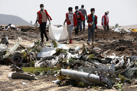Ethiopian Red Cross workers carry a body bag with the remains of Ethiopian Airlines Flight ET 302 plane crash victims at the scene of a plane crash, near the town of Bishoftu, southeast of Addis Ababa, Ethiopia March 12, 2019.