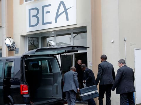 Men unload a case from a diplomatic car from the Ethiopian Embassy outside the headquarters of France's BEA air accident investigation agency in Le Bourget, north of Paris, France, March 14, 2019.