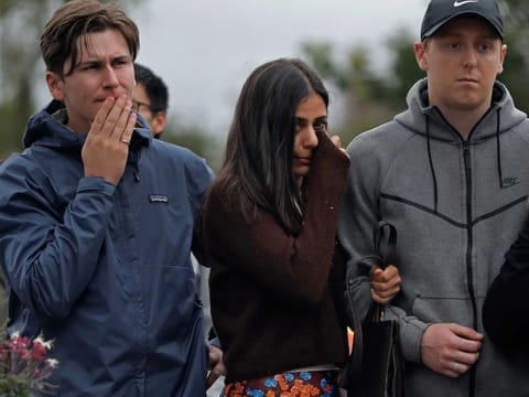 Mourners paying their respects at a makeshift memorial near the Masjid Al Noor mosque, Saturday, March 16, 2019, in Christchurch, New Zealand. 