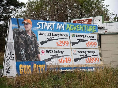 An advertisement for the Gun City store that has reportedly upset locals is seen on the outskirts of Christchurch on March 18, 2019.