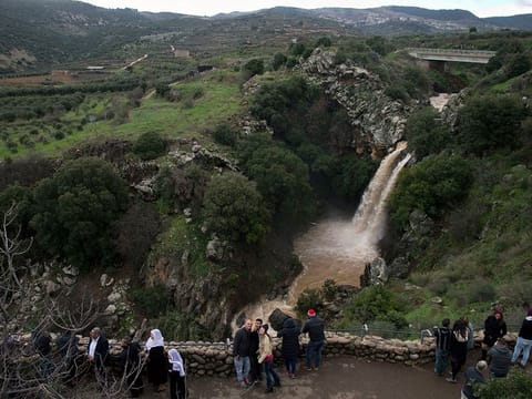 People visit the Sa'ar waterfall, near the Druze village of Ein Qiniyya in the Israeli-occupied side of Golan Heights. 