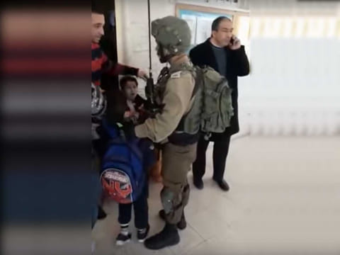 An Israeli army soldier is seen grabbing the 9-year-old boy from school after the boy allegedly threw stones at them.
